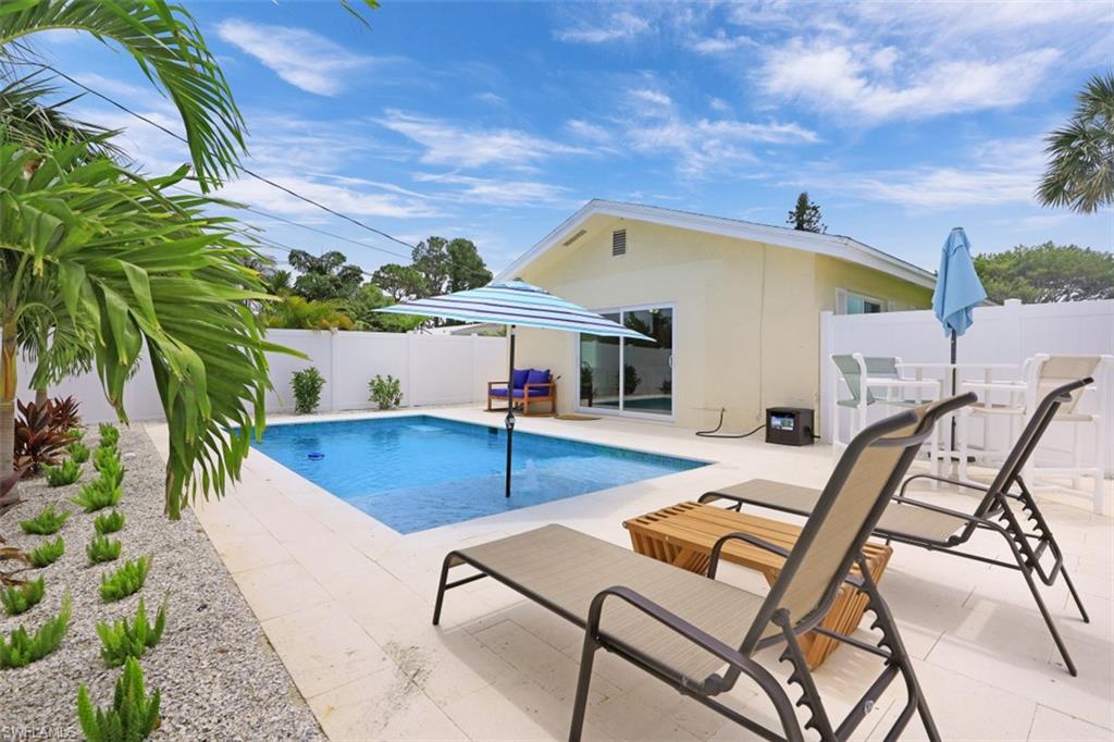 701 93rd Avenue North Naples, FL 34108 - Photo 2 of 33 a view of a swimming pool with chair and table