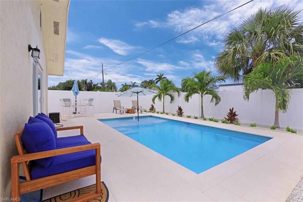 701 93rd Avenue North Naples, FL 34108 - Photo 25 of 33 a view of swimming pool with outdoor seating and plants