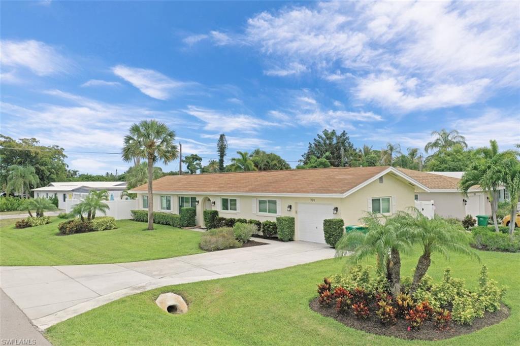 701 93rd Avenue North Naples, FL 34108 - Photo 6 of 33 a view of a house with a yard
