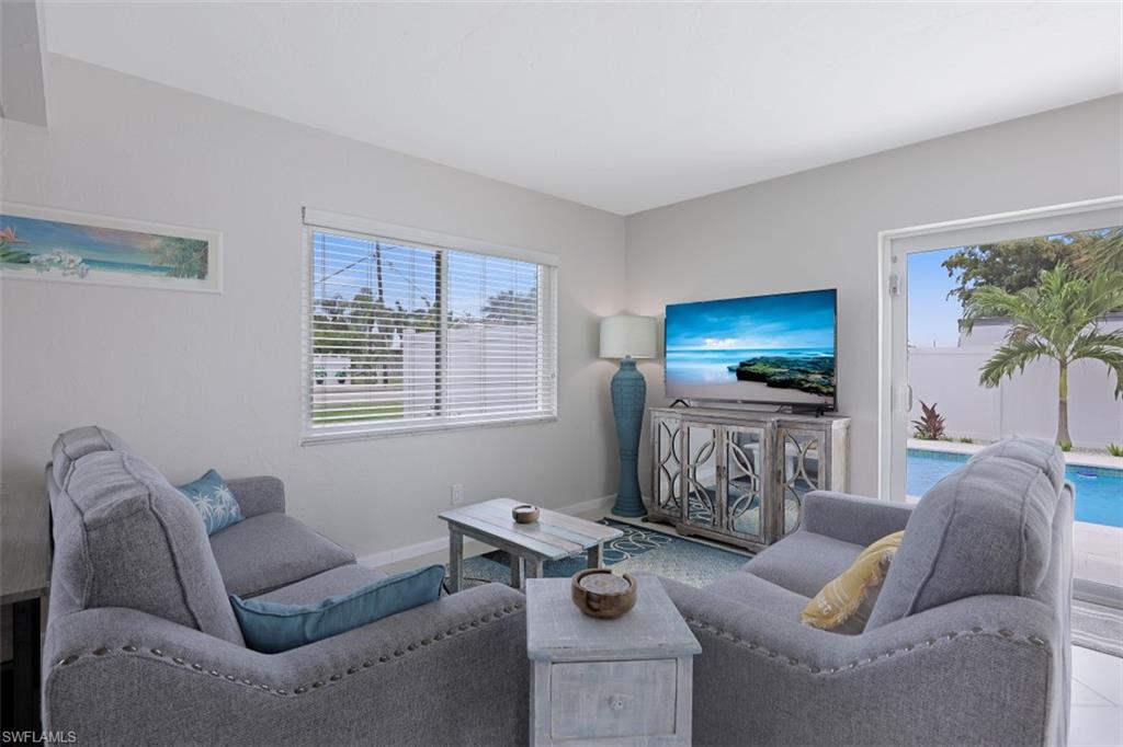 701 93rd Avenue North Naples, FL 34108 - Photo 7 of 33 a living room with furniture and a flat screen tv
