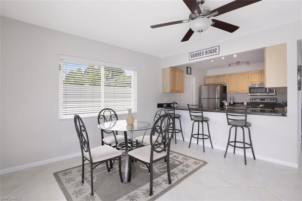 701 93rd Avenue North Naples, FL 34108 - Photo 10 of 33 a view of a dining room with furniture and a chandelier