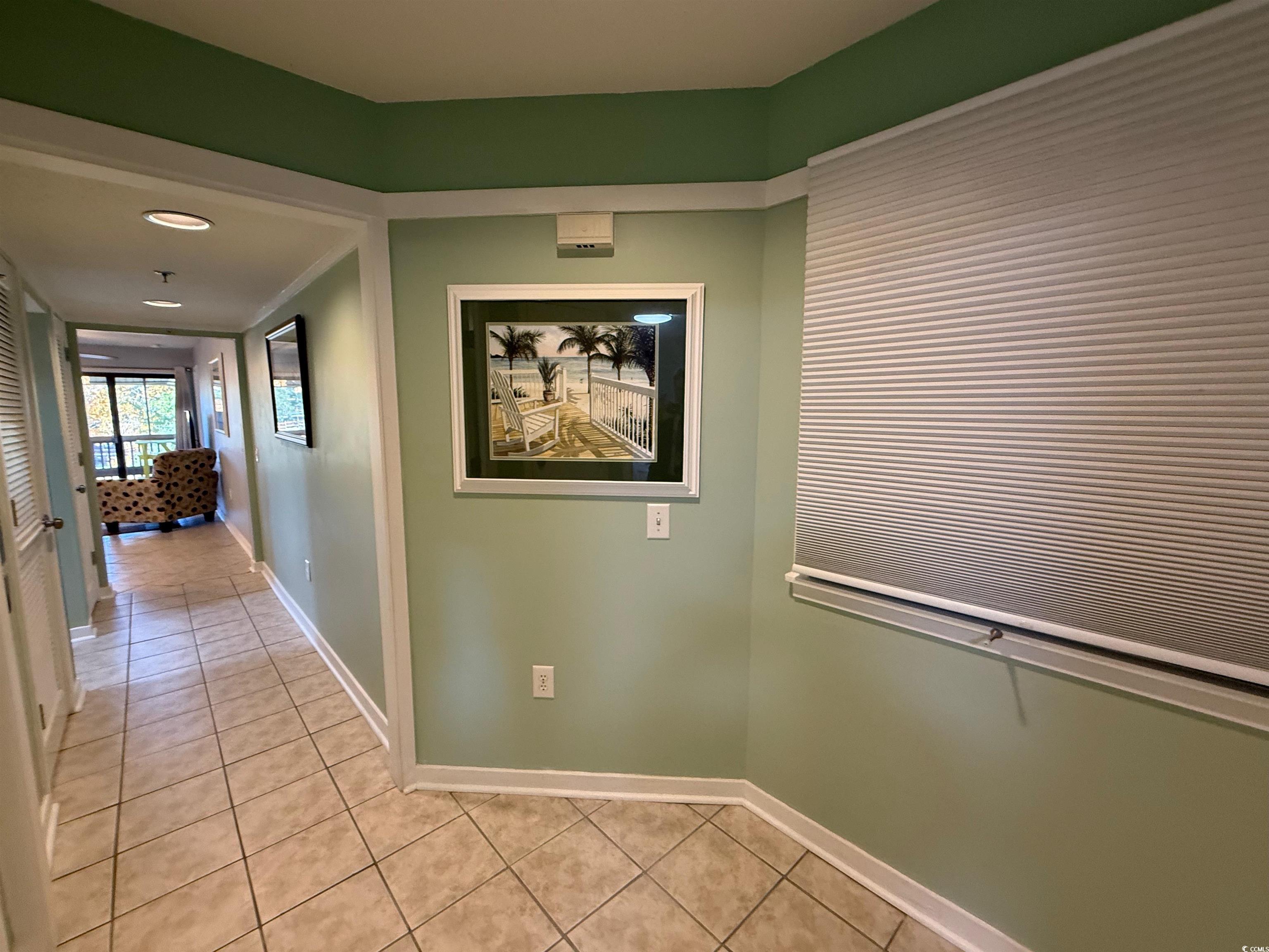 410 Melrose Place, Unit 310 Myrtle Beach, SC 29572 - Photo 2 of 39 Corridor featuring light tile patterned floors and baseboards