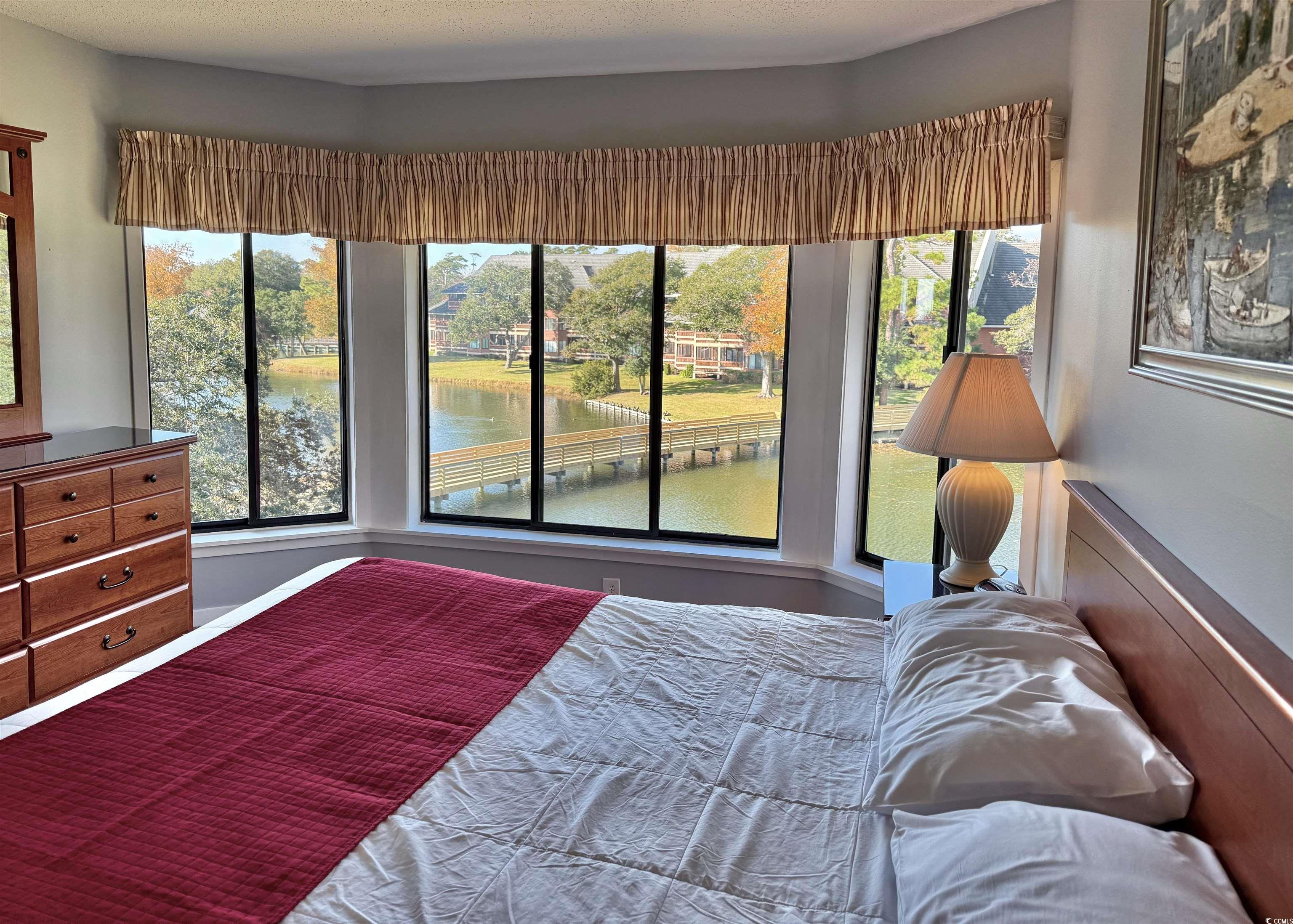 410 Melrose Place, Unit 310 Myrtle Beach, SC 29572 - Photo 21 of 39 Bedroom featuring a water view and multiple windows