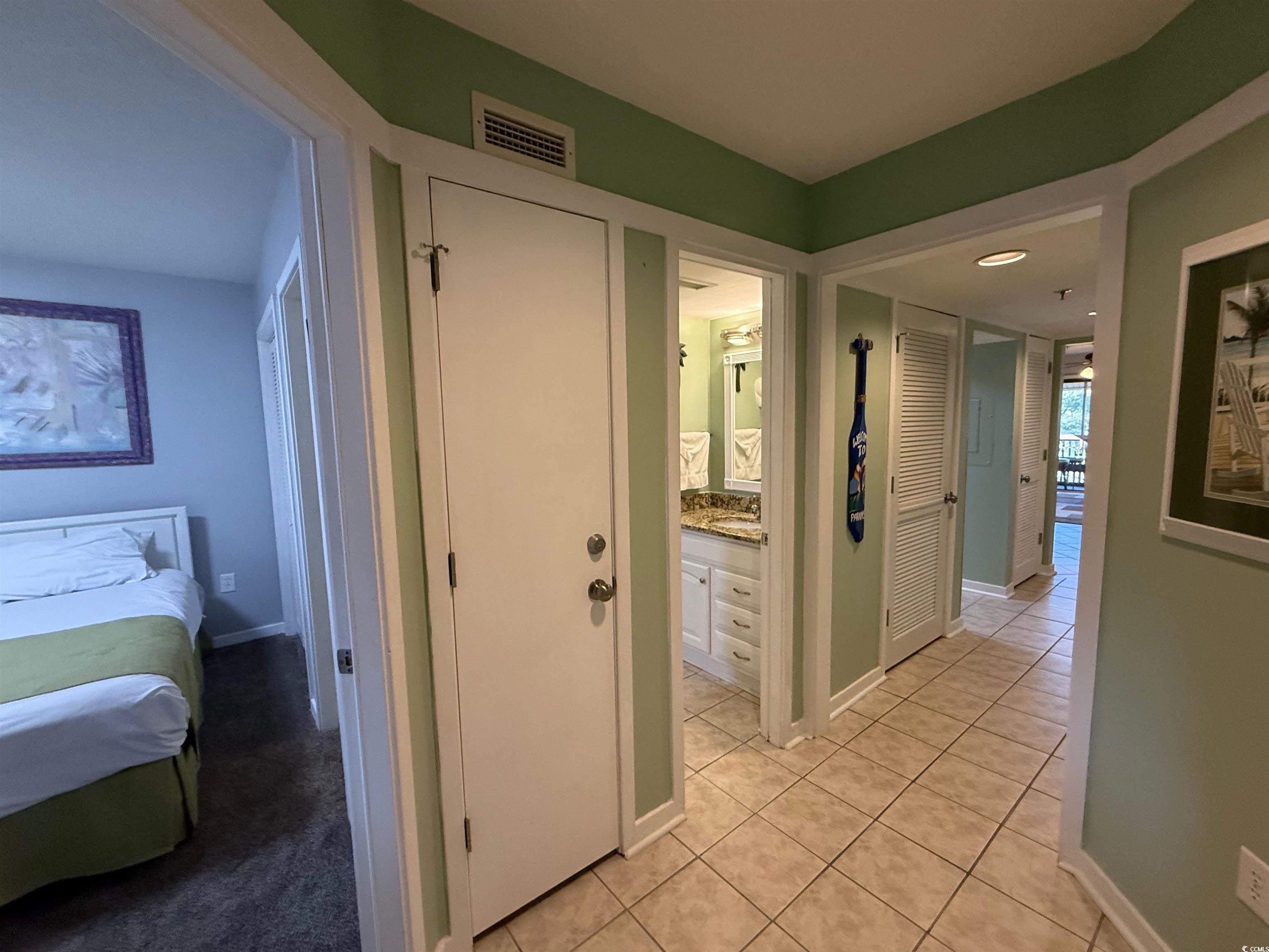 410 Melrose Place, Unit 310 Myrtle Beach, SC 29572 - Photo 31 of 39 Hallway with light tile patterned floors and baseboards
