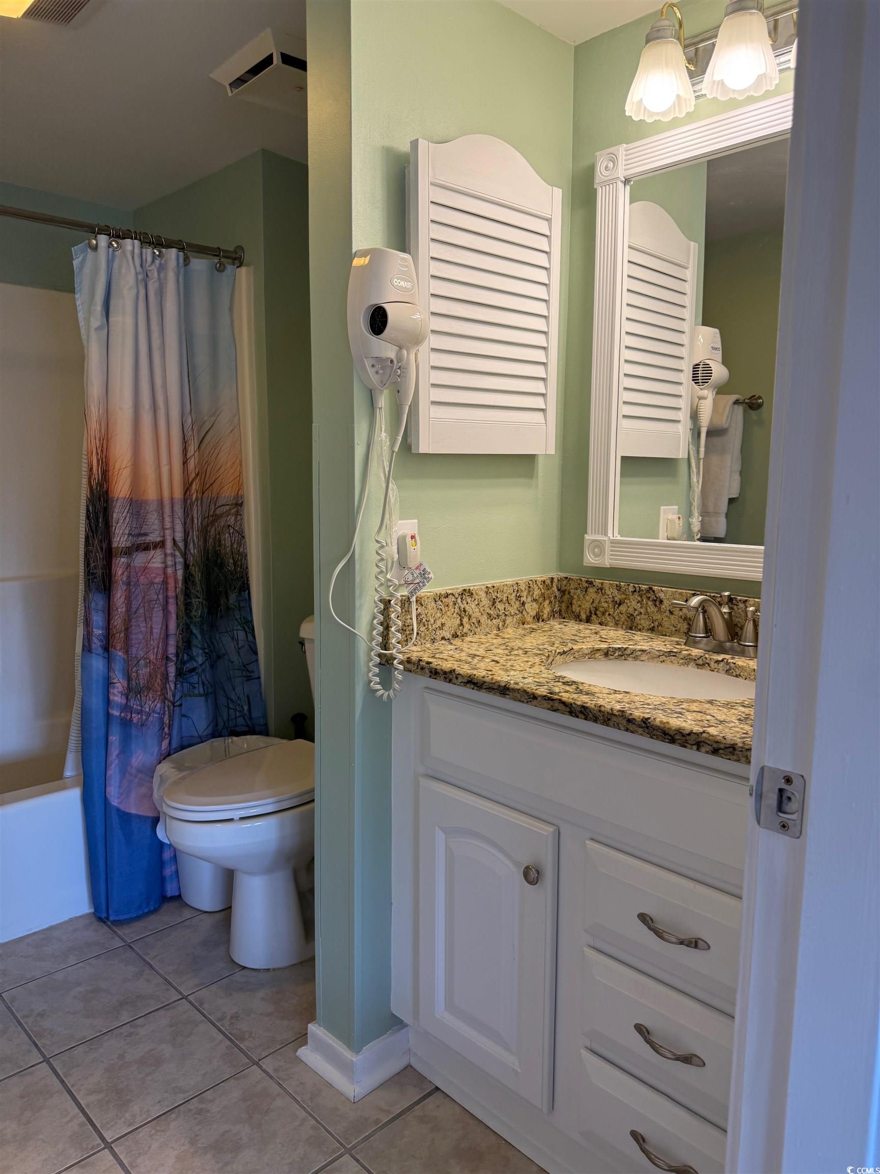 410 Melrose Place, Unit 310 Myrtle Beach, SC 29572 - Photo 35 of 39 Bathroom with vanity, shower / bathtub combination with curtain, and light tile patterned floors