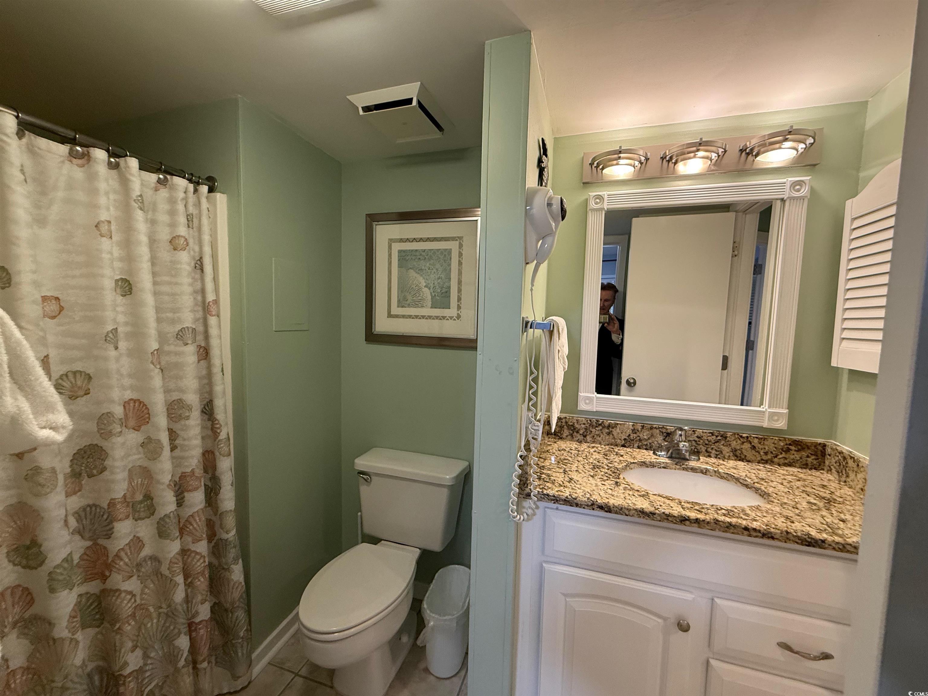 410 Melrose Place, Unit 310 Myrtle Beach, SC 29572 - Photo 36 of 39 Bathroom with curtained shower, vanity, and tile patterned flooring
