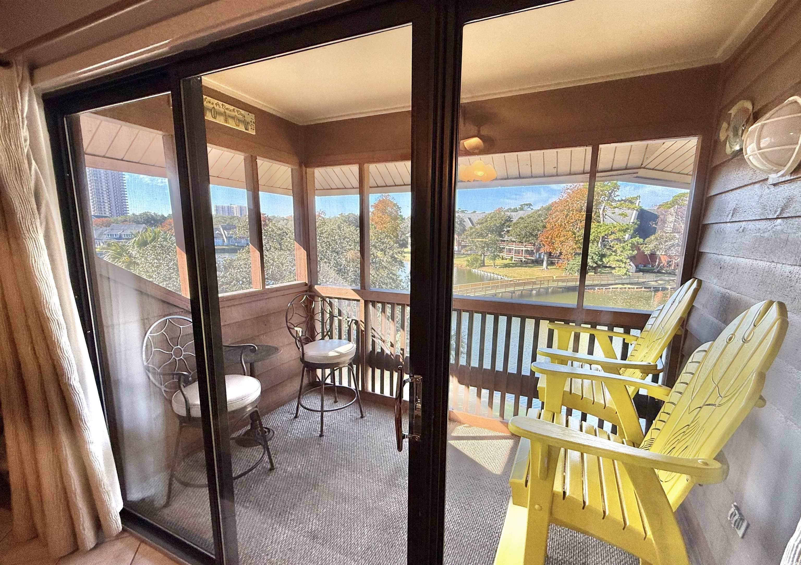 410 Melrose Place, Unit 310 Myrtle Beach, SC 29572 - Photo 7 of 39 Sunroom featuring a water view