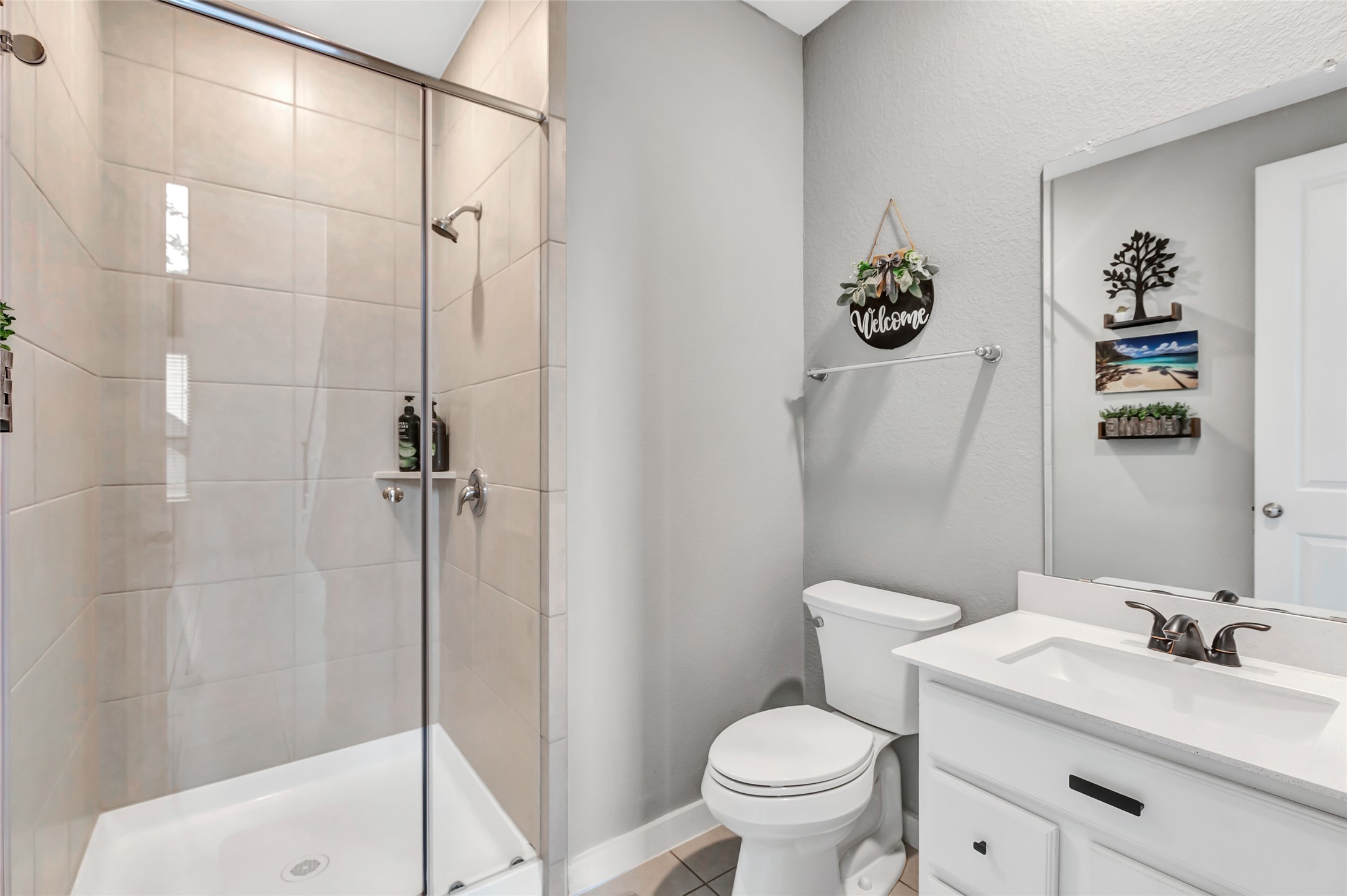 527 Chestnut Reef Court Conroe, TX 77304 - Photo 12 of 40 a bathroom with a sink a toilet and shower