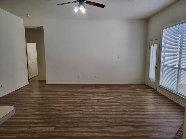 a view of a room with wooden floor