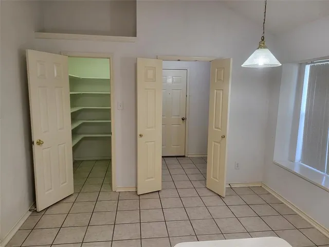 a view of an empty room and window in a room