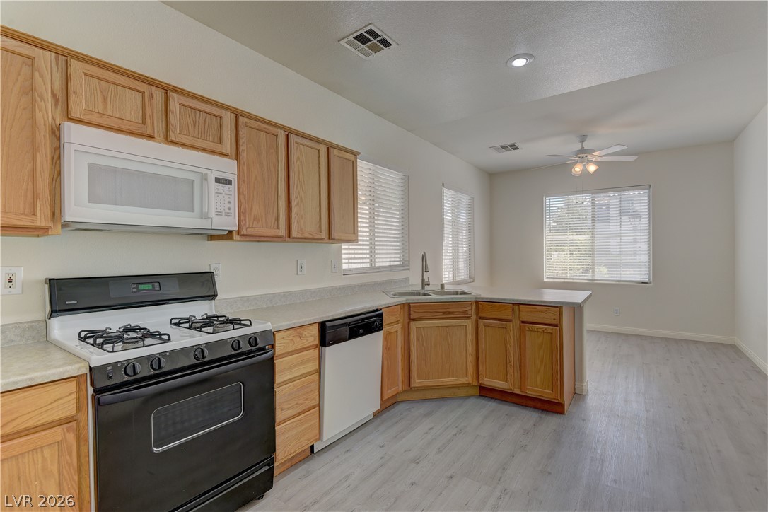 4613 Rising Cove Street Las Vegas, NV 89129 - Photo 6 of 20 This bright kitchen features ample cabinetry and a functional layout, perfect for daily living and entertaining.