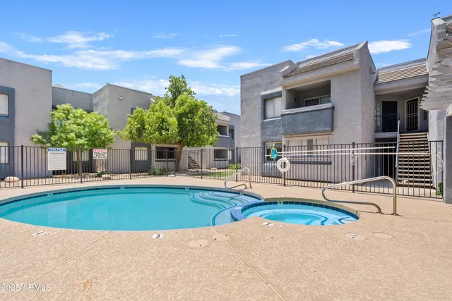 a view of a house with swimming pool and sitting area