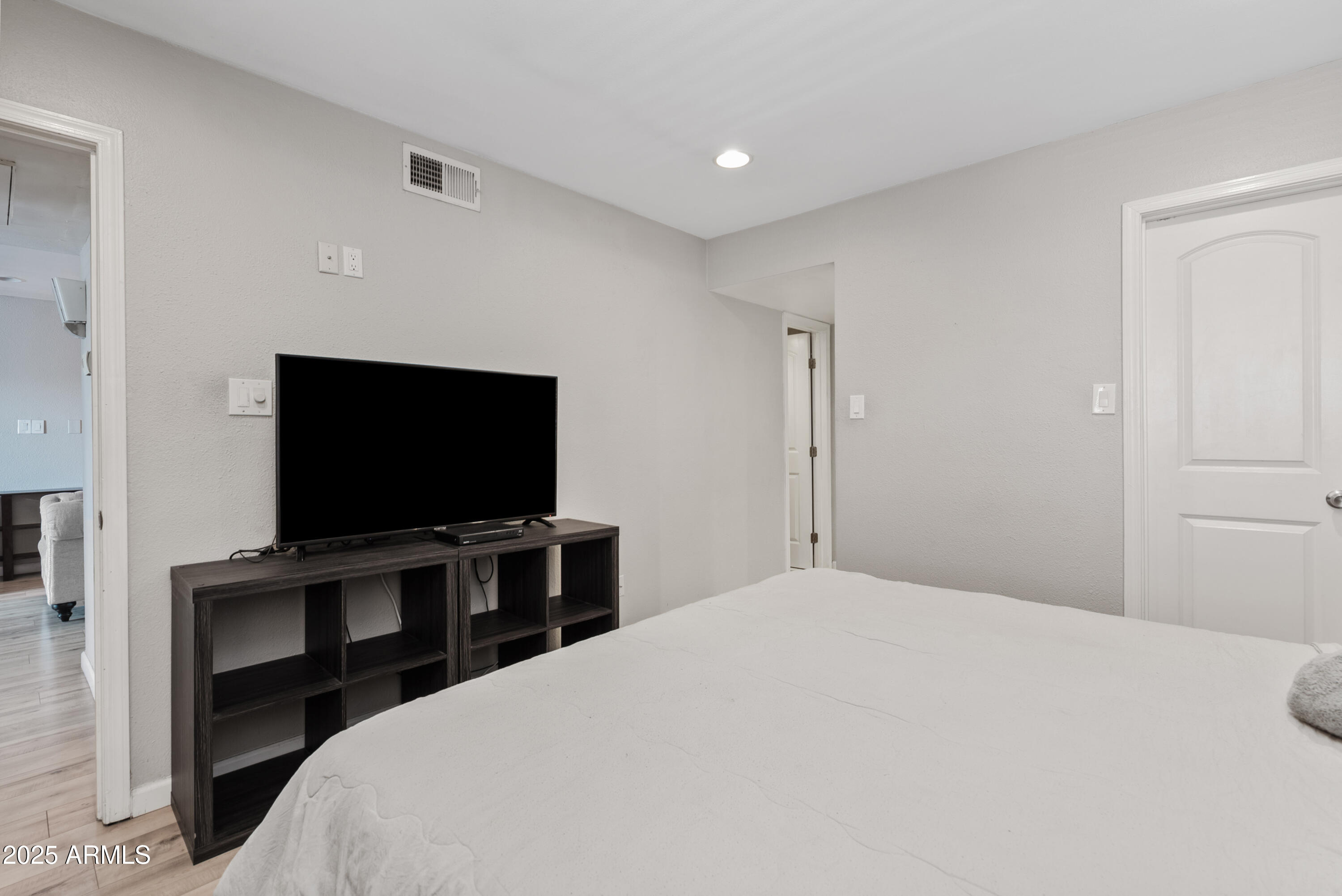 4410 North Longview Avenue, Unit 224 Phoenix, AZ 85014 - Photo 14 of 23 a bedroom with a bed and a flat screen tv