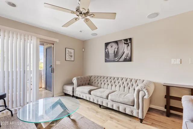 a living room with furniture and a painting