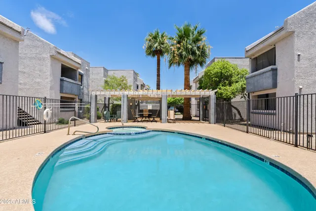 a view of a house with swimming pool and sitting area