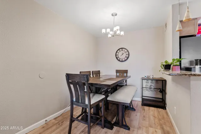 a view of a dining room with furniture and chandelier