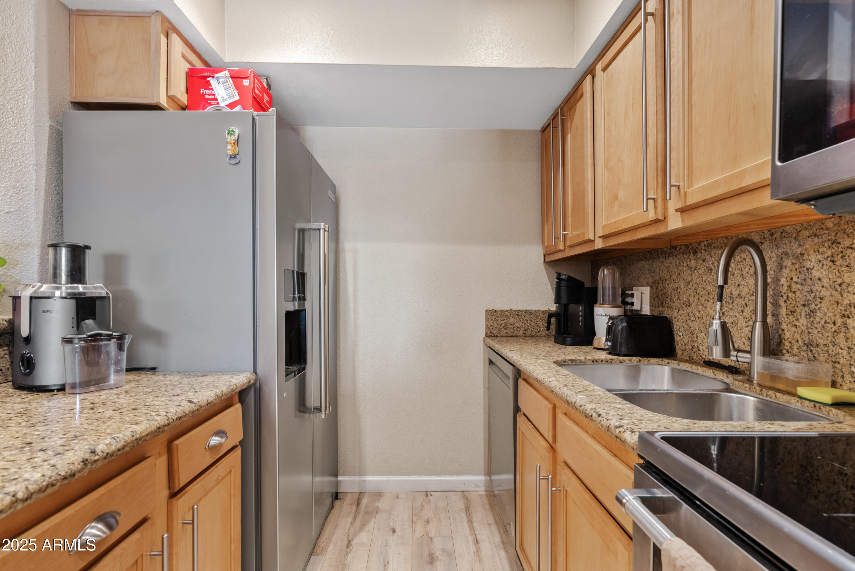 4410 North Longview Avenue, Unit 224 Phoenix, AZ 85014 - Photo 8 of 23 a kitchen with stainless steel appliances granite countertop a sink refrigerator and microwave