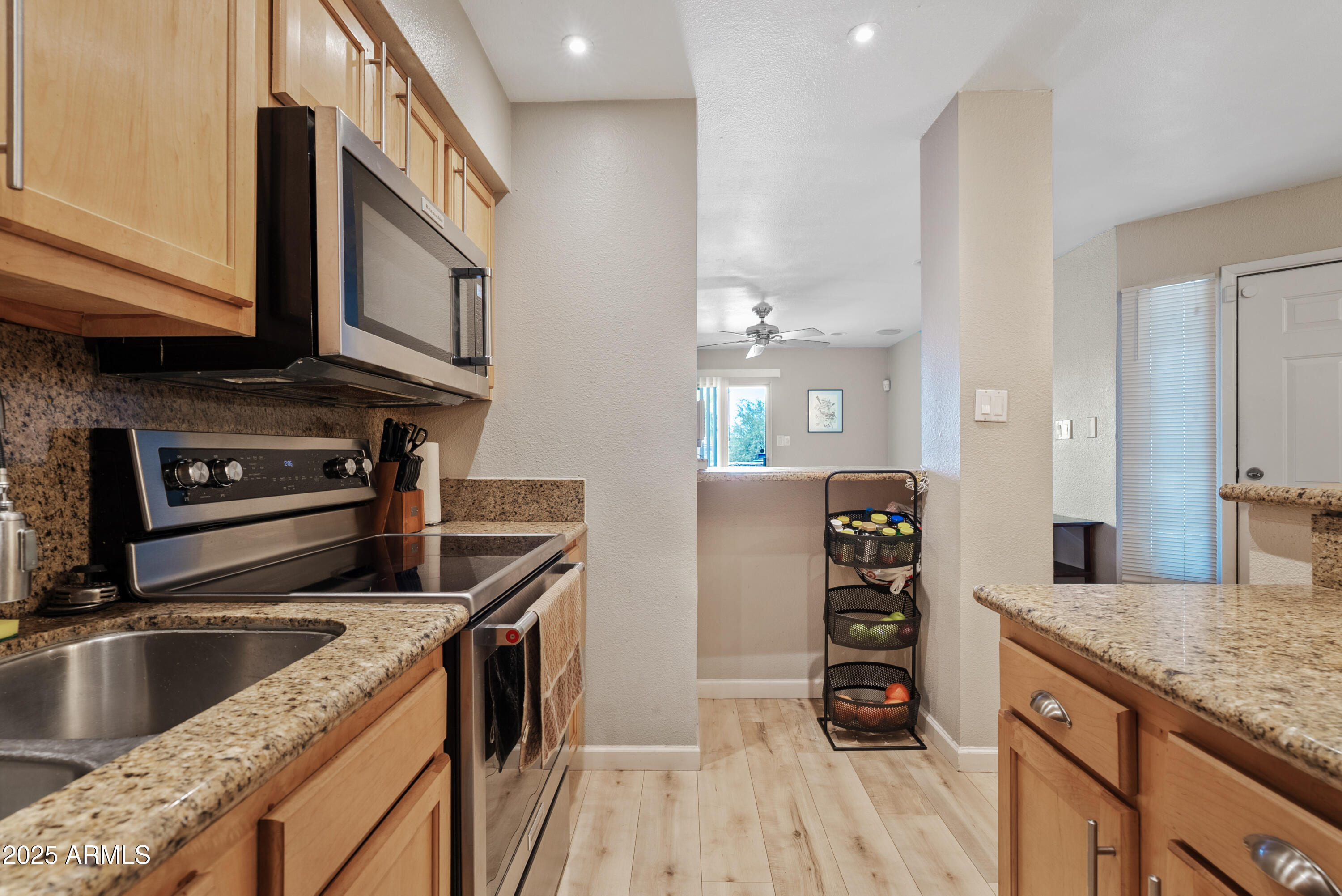 4410 North Longview Avenue, Unit 224 Phoenix, AZ 85014 - Photo 9 of 23 a kitchen with stainless steel appliances granite countertop a kitchen island a stove and a wooden floor