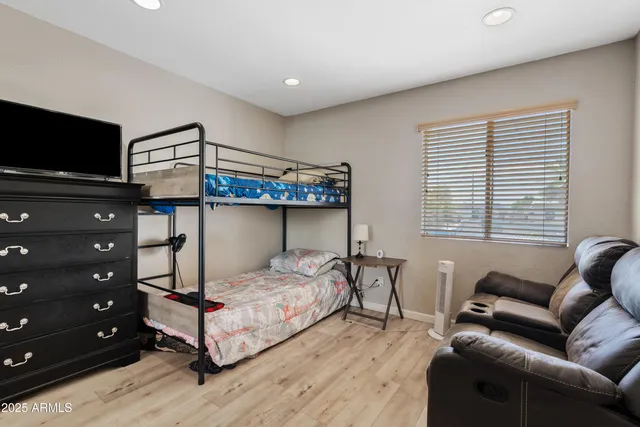 a bedroom with a bed and a television