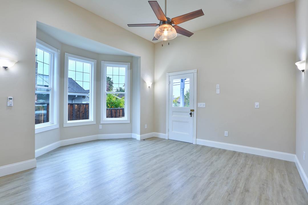 5121 Bucknall Road San Jose, CA 95130 - Photo 13 of 26 a view of an empty room with wooden floor and a window