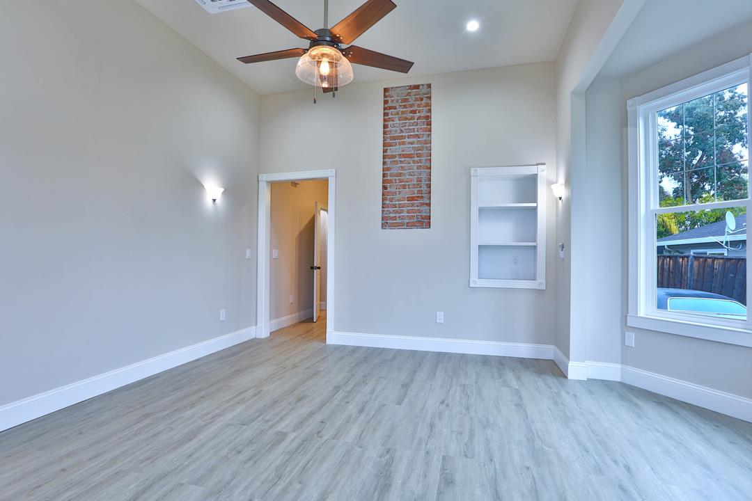 5121 Bucknall Road San Jose, CA 95130 - Photo 14 of 26 an empty room with wooden floor fan and windows