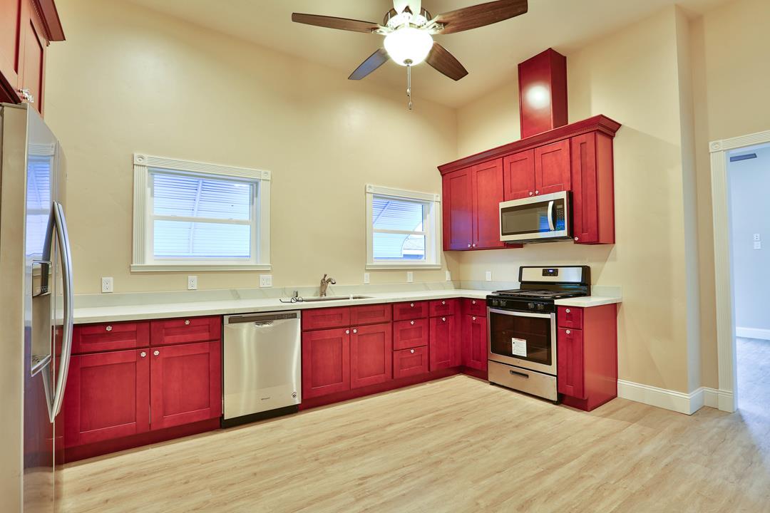 5121 Bucknall Road San Jose, CA 95130 - Photo 16 of 26 a kitchen with stainless steel appliances granite countertop a stove sink microwave and cabinets