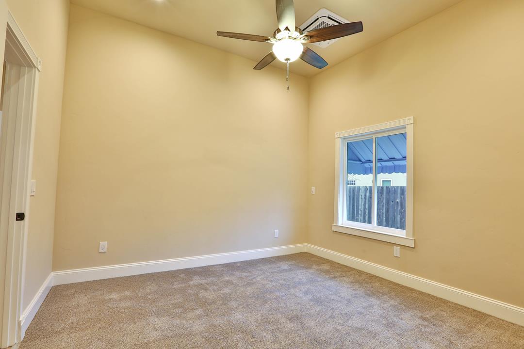 5121 Bucknall Road San Jose, CA 95130 - Photo 18 of 26 an empty room with a window and a fan
