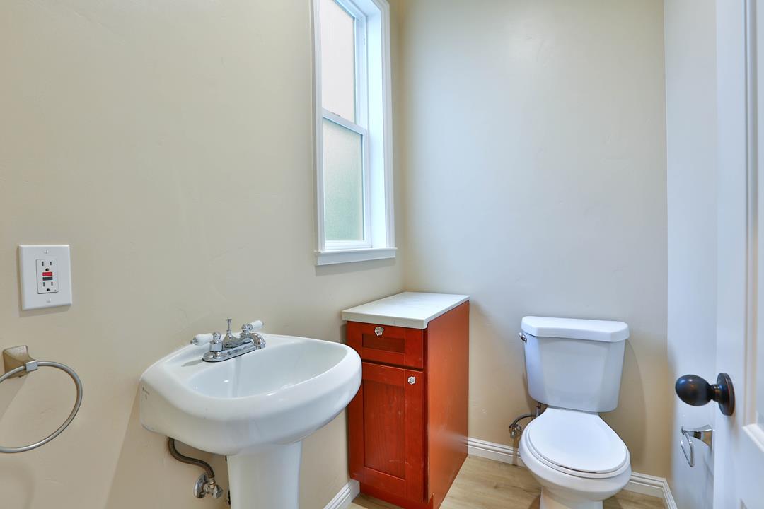 5121 Bucknall Road San Jose, CA 95130 - Photo 22 of 26 a bathroom with a sink a toilet and a mirror