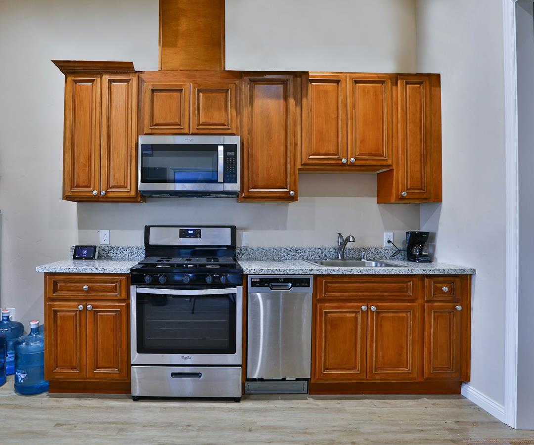 5121 Bucknall Road San Jose, CA 95130 - Photo 23 of 26 a kitchen with stainless steel appliances granite countertop a stove and a microwave