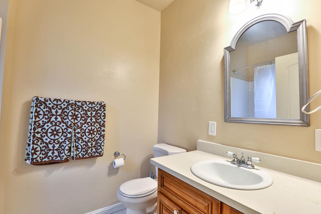 5121 Bucknall Road San Jose, CA 95130 - Photo 25 of 26 a bathroom with a sink a toilet and a mirror