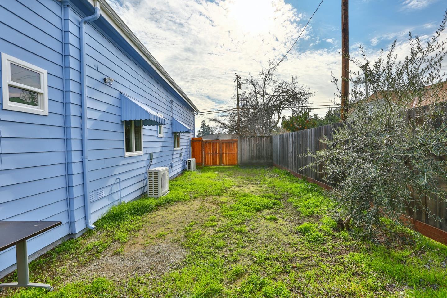 5121 Bucknall Road San Jose, CA 95130 - Photo 8 of 26 a view of a backyard with large trees and wooden fence