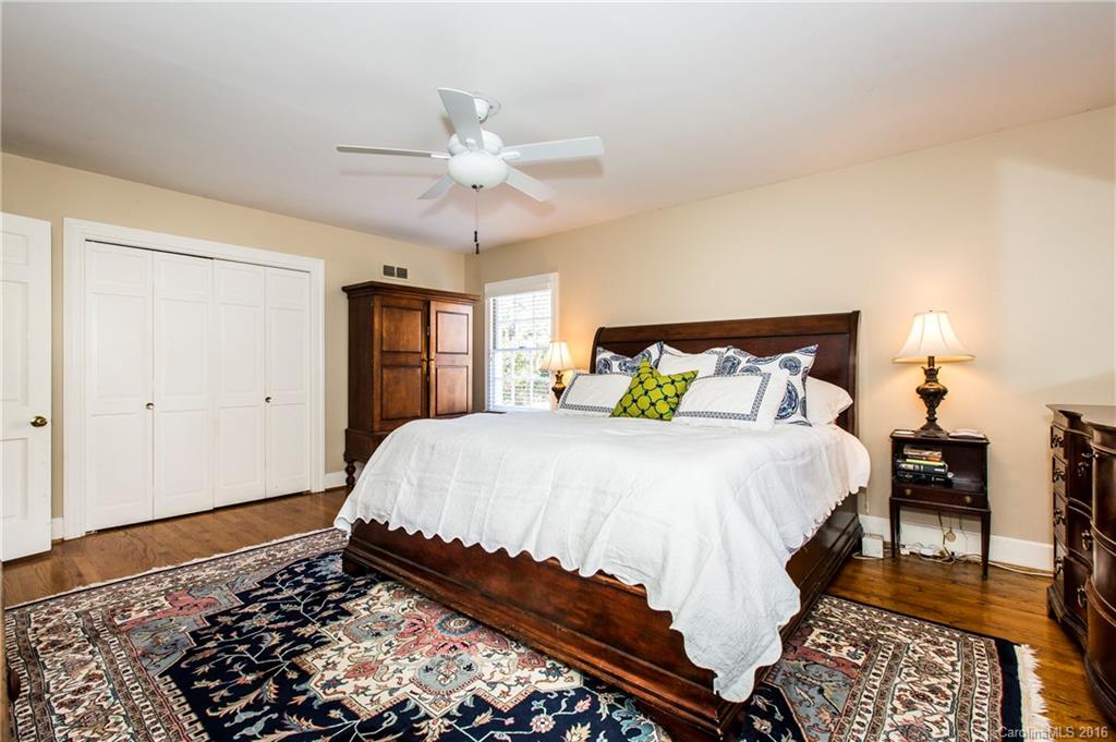 2307 Overhill Road Charlotte, NC 28211 - Photo 12 of 24 a bedroom with a bed and a chandelier