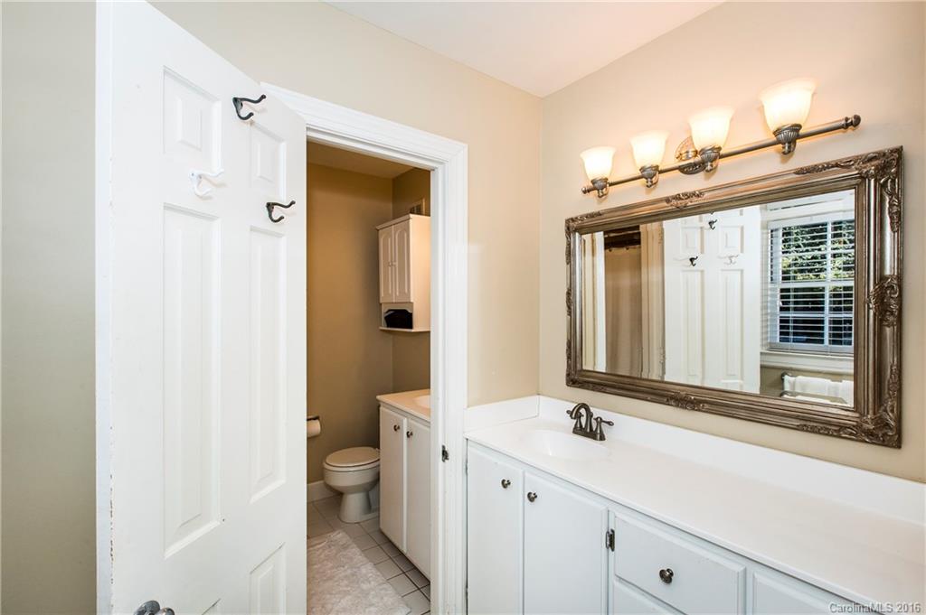 2307 Overhill Road Charlotte, NC 28211 - Photo 13 of 24 a bathroom with a sink a toilet and a large mirror