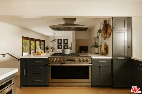 a kitchen with stainless steel appliances granite countertop a stove and a refrigerator