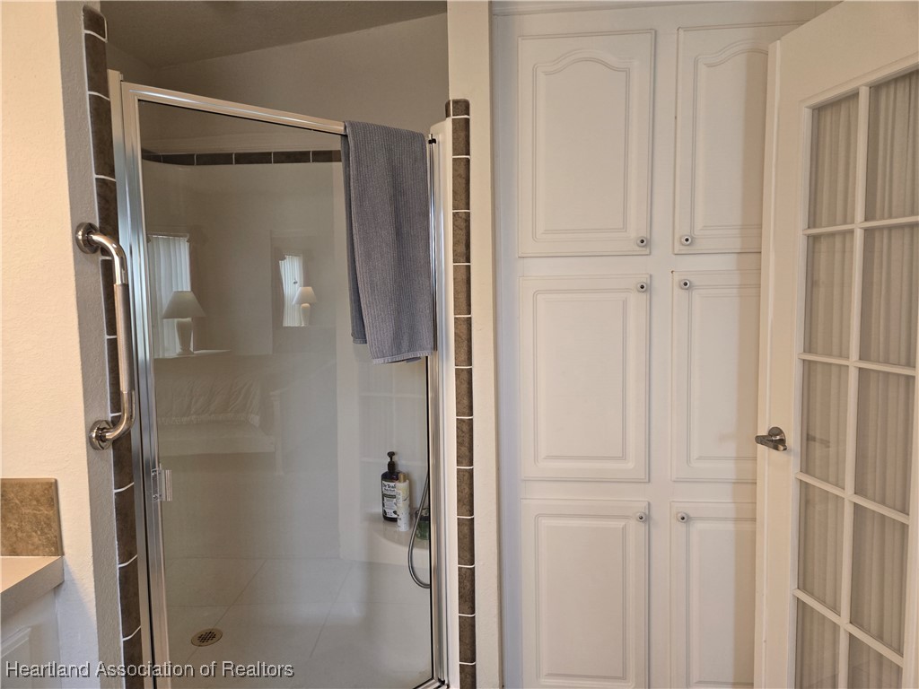 3312 Beartooth Pass Sebring, FL 33872 - Photo 27 of 39 a bathroom with a glass shower door