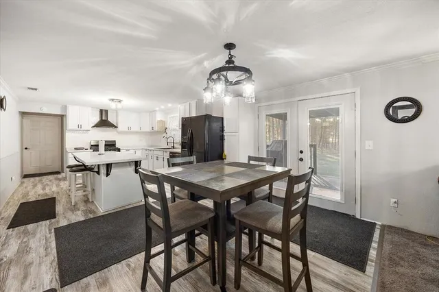 a kitchen with a table and chairs in it