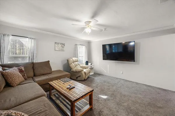 a living room with furniture and a flat screen tv