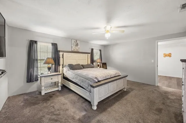 a bedroom with a bed and window