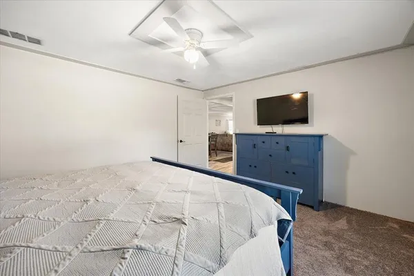 a bedroom with a bed and a flat screen tv