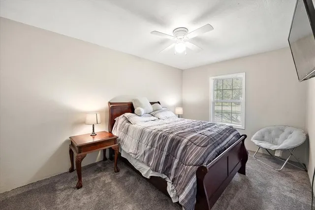 a bedroom with a bed and window