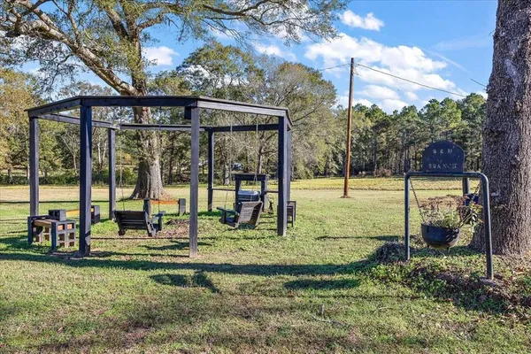 a view of wooden house with a yard