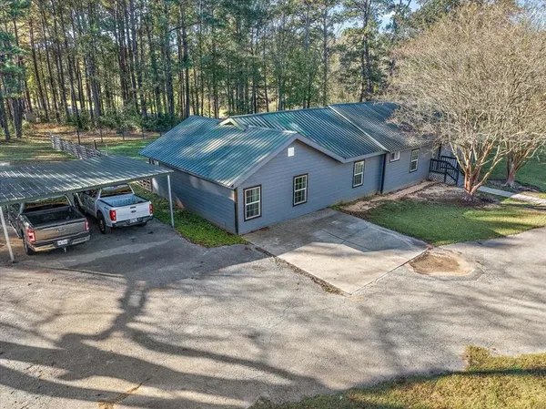 a view of a house with a yard and sitting area