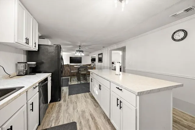 a kitchen with cabinets and stainless steel appliances