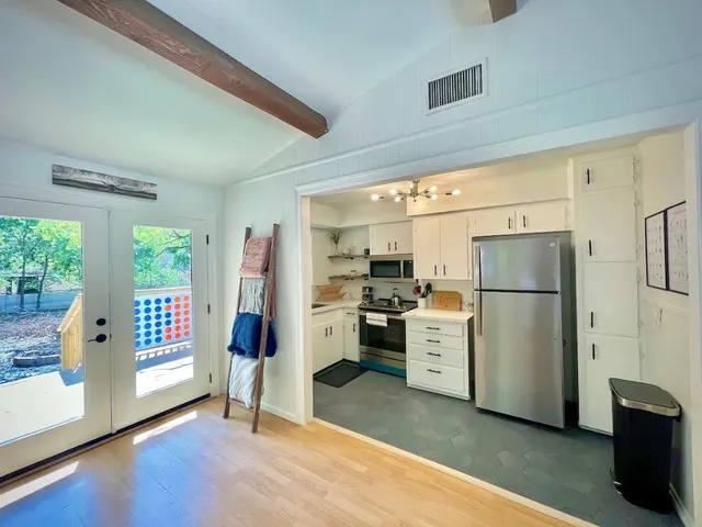 a kitchen with a refrigerator a stove top oven a refrigerator and a window