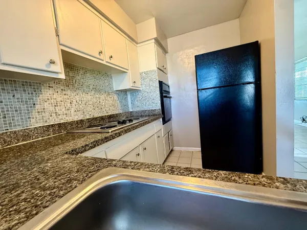 a kitchen with a refrigerator and a counter top