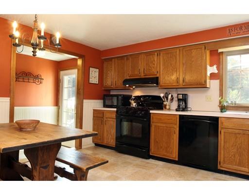 28 McGuire Road Sutton, MA 01590 - Photo 11 of 30 a kitchen with stainless steel appliances kitchen island granite countertop a stove a sink dishwasher and cabinets with wooden floor