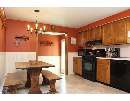 28 McGuire Road Sutton, MA 01590 - Photo 12 of 30 a kitchen with stainless steel appliances kitchen island granite countertop a sink cabinets and wooden floor