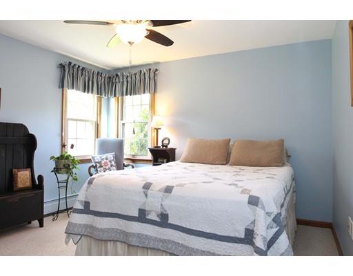 28 McGuire Road Sutton, MA 01590 - Photo 14 of 30 a bedroom with a bed and a chandelier