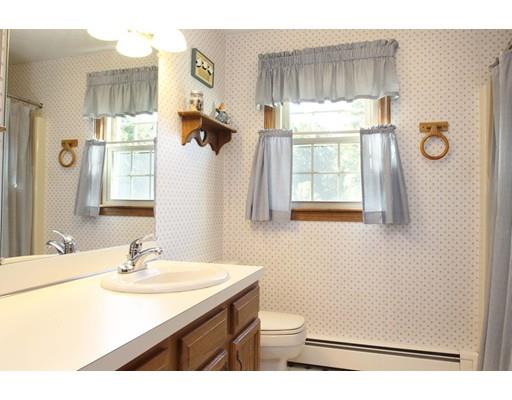 28 McGuire Road Sutton, MA 01590 - Photo 15 of 30 a bathroom with a sink a toilet and a window