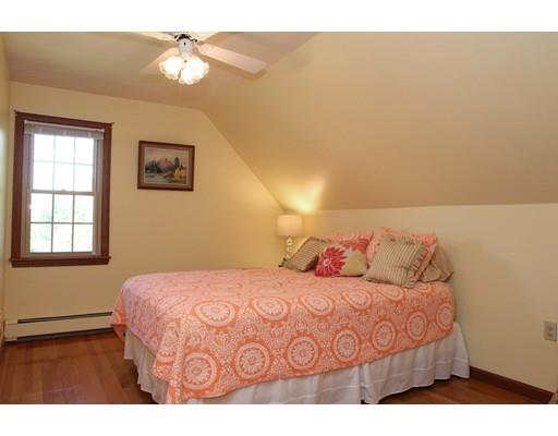 28 McGuire Road Sutton, MA 01590 - Photo 18 of 30 a bedroom with a large bed and a chandelier